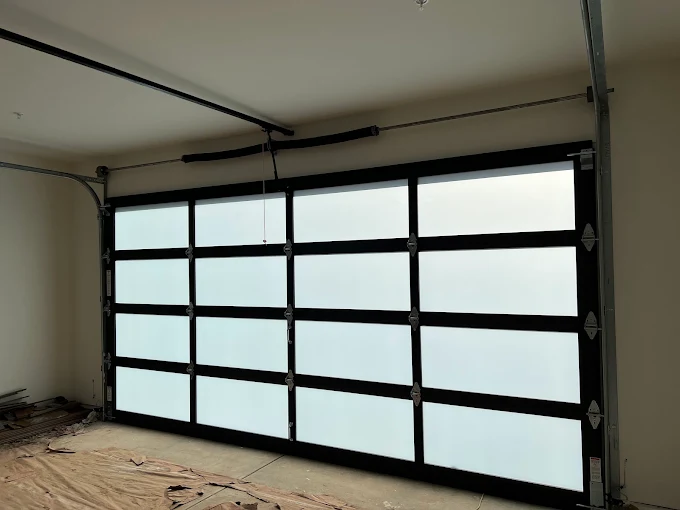 Full-view glass garage door installed in a home garage